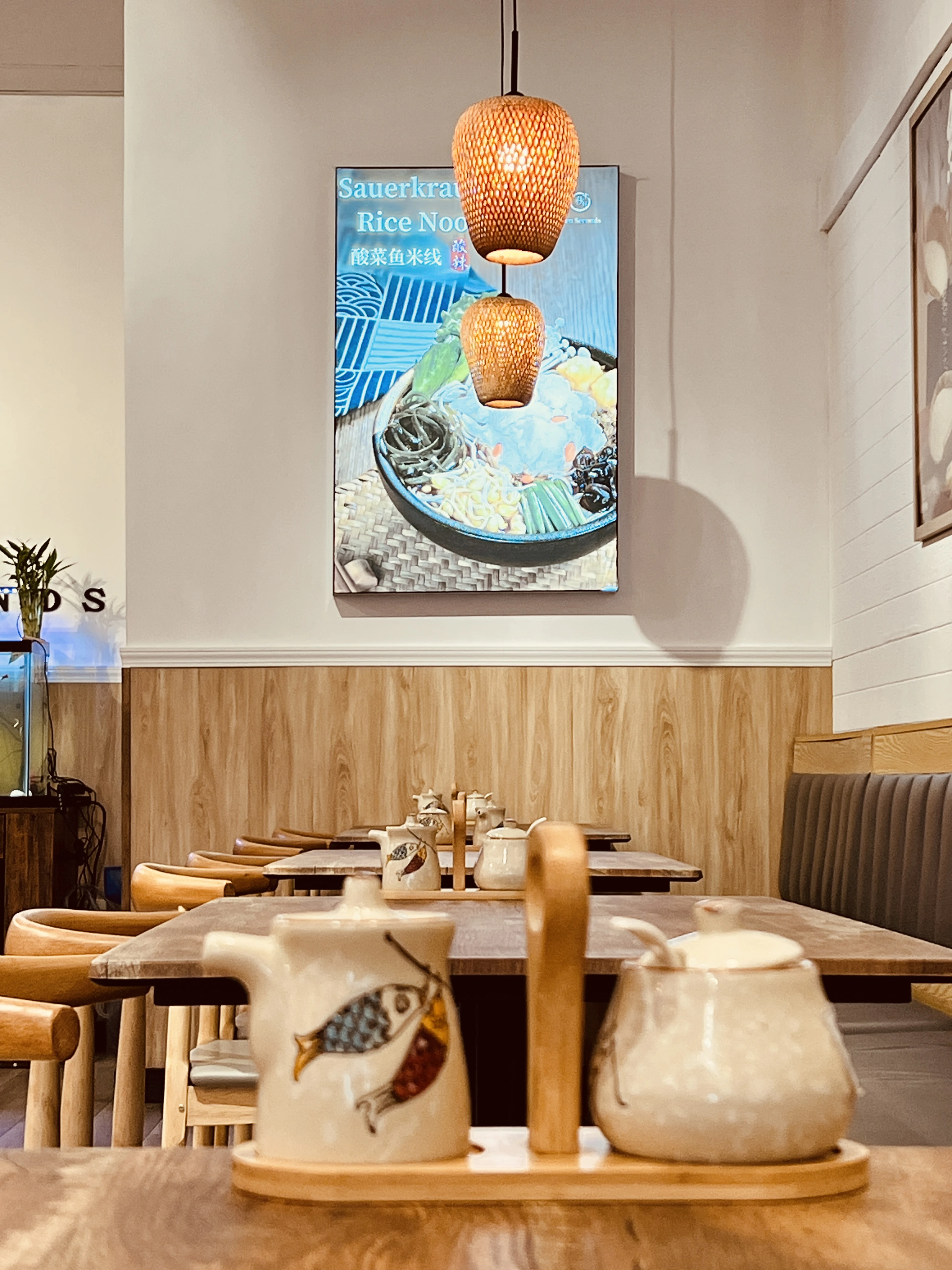 Cozy interior tables set with tea pots and bamboo chairs